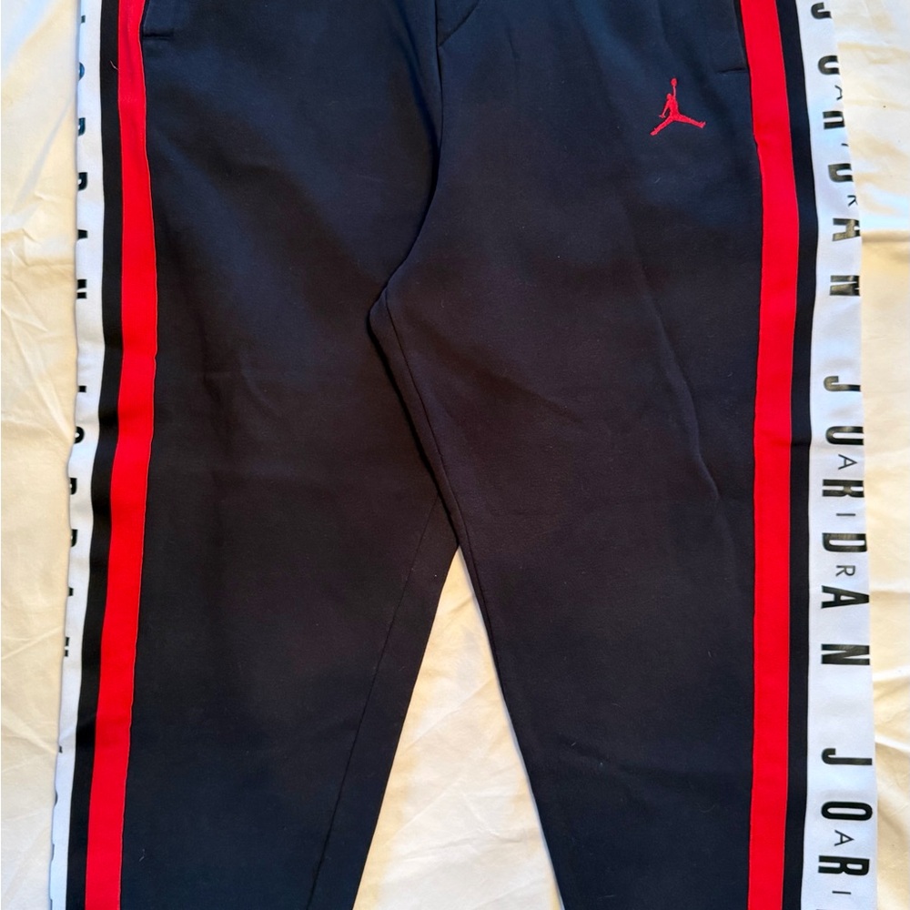 Men’s Jordan Black Joggers with Red and White Stripes.